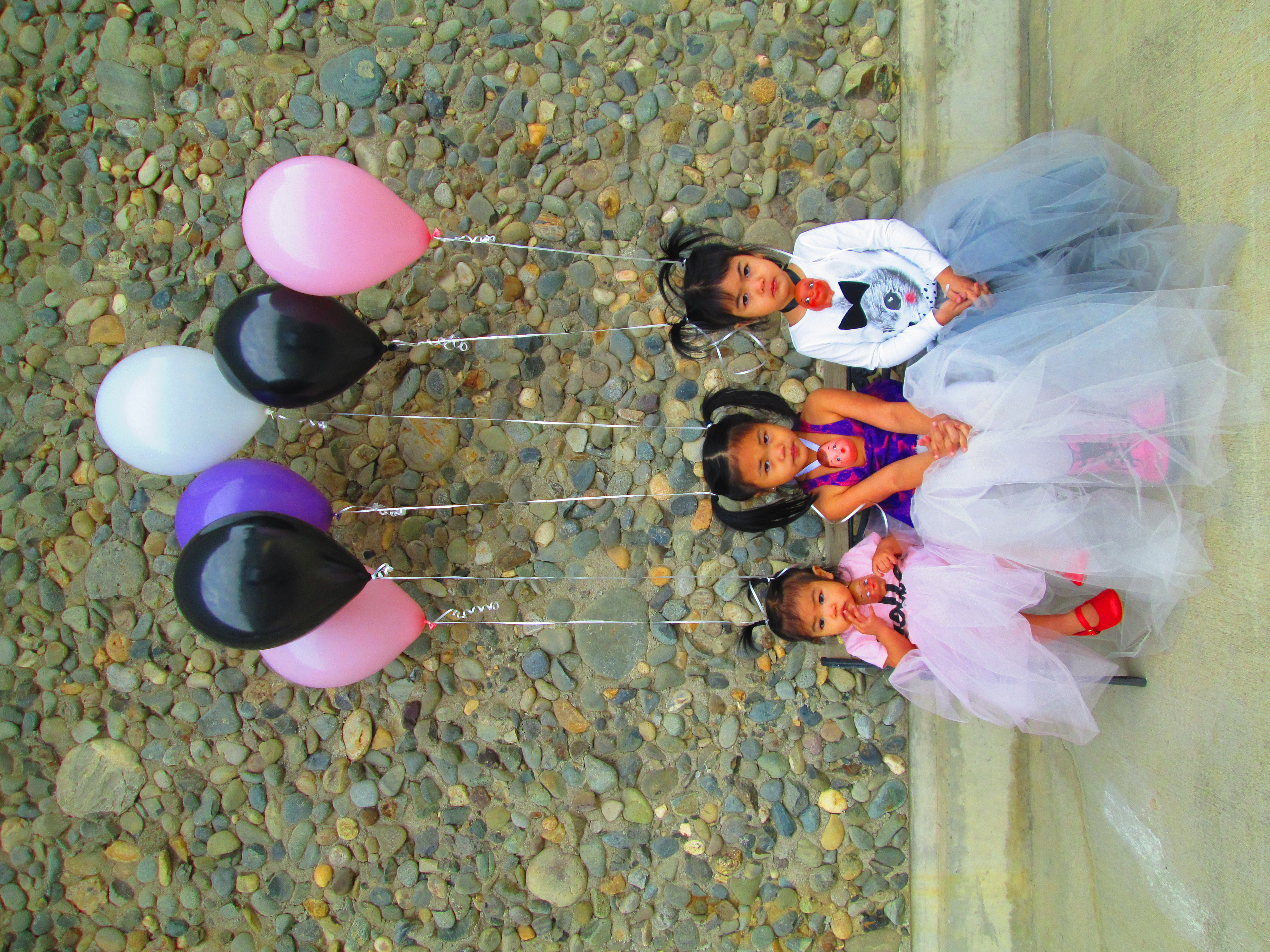 emmalou's three daughters in dresses with balloons