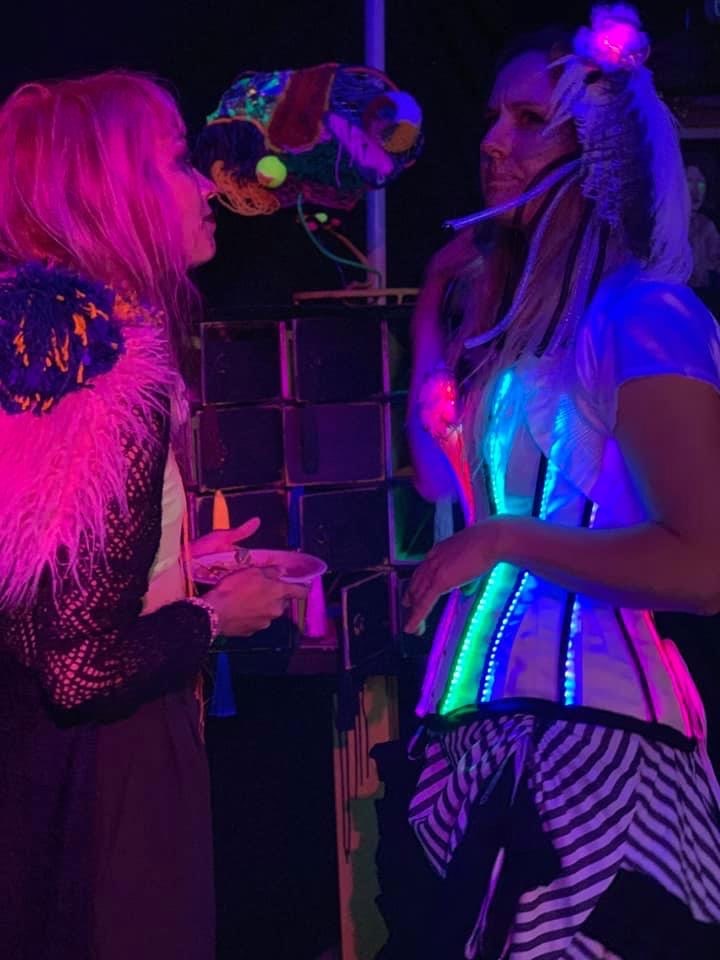 emmalou ras and friend in colored light at upcycle event
