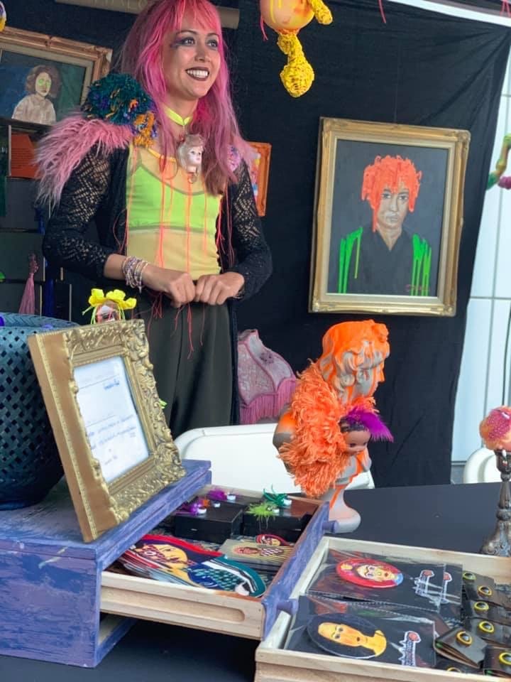 Emmalou ras at merch table upcycle event