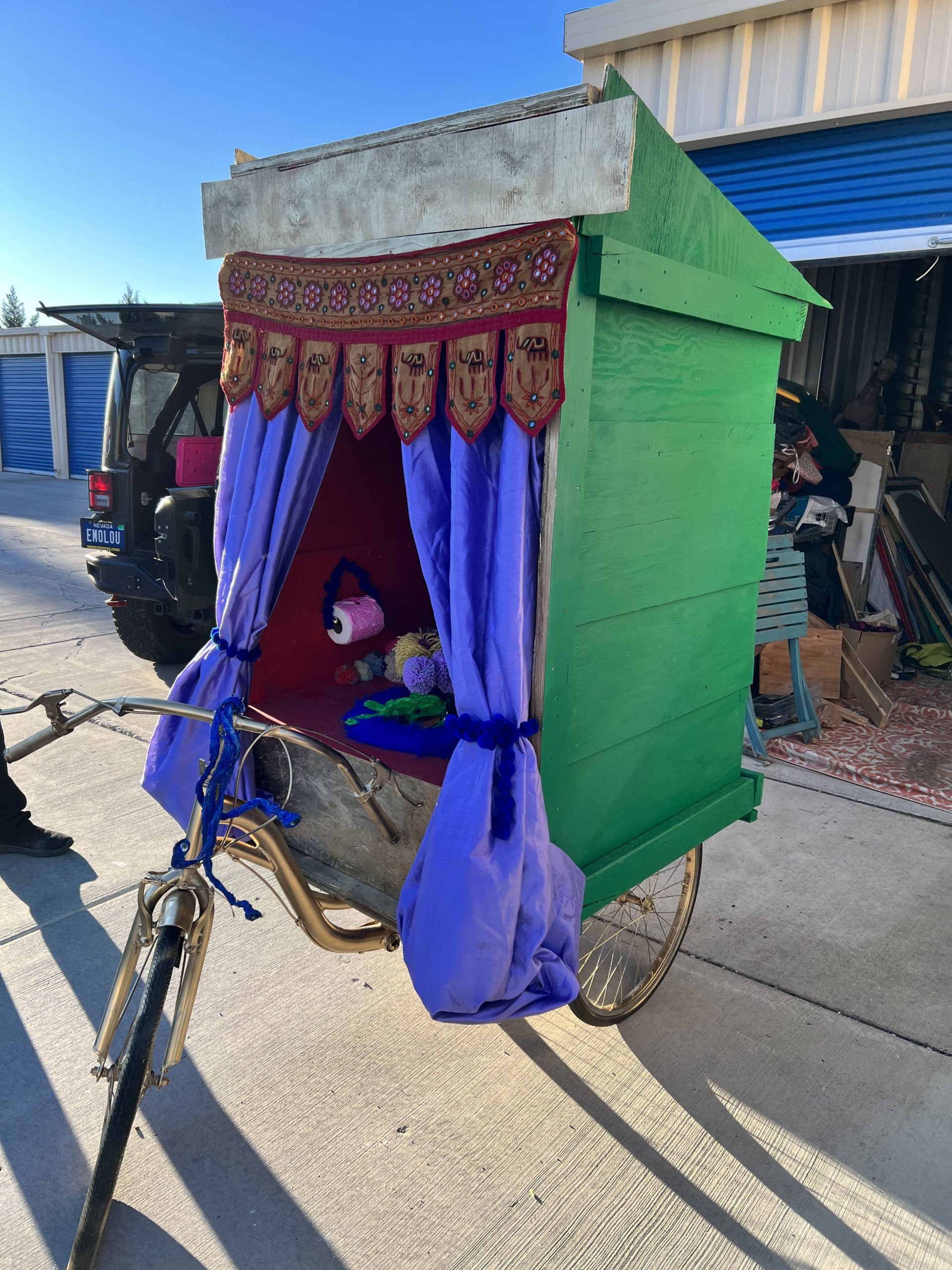 lavendar and green outhouse on bike